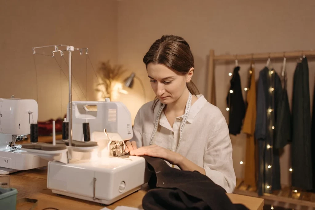 pexels-pavel-danilyuk-6461167 Woman in white cotton shirt stitching a garment while having a measuring tape around her neck, this is where we are focused on Continuous improvement to make better decisions and work ethic