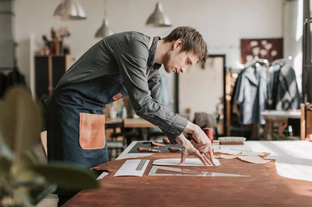 a man in workshop crafting a clothing product with sustainable process