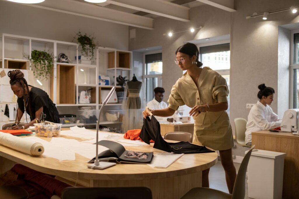 Fashion professionals collaborating in a design studio, showcasing product development, apparel sourcing, and fashion supply chain teamwork. This image illustrates garment production planning, private label design, and creative workflow management.